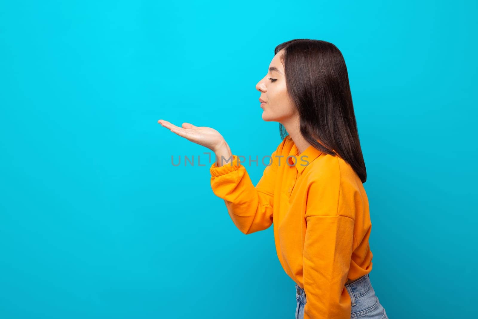 profile portrait of amazing funny mixed races woman sending air kiss .