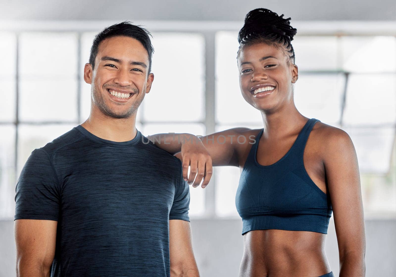 Fitness, portrait or personal trainer with a black woman at a gym for training, exercise or body workout. Motivation, friends or happy sports athletes in a partnership smile with pride in health club by YuriArcurs