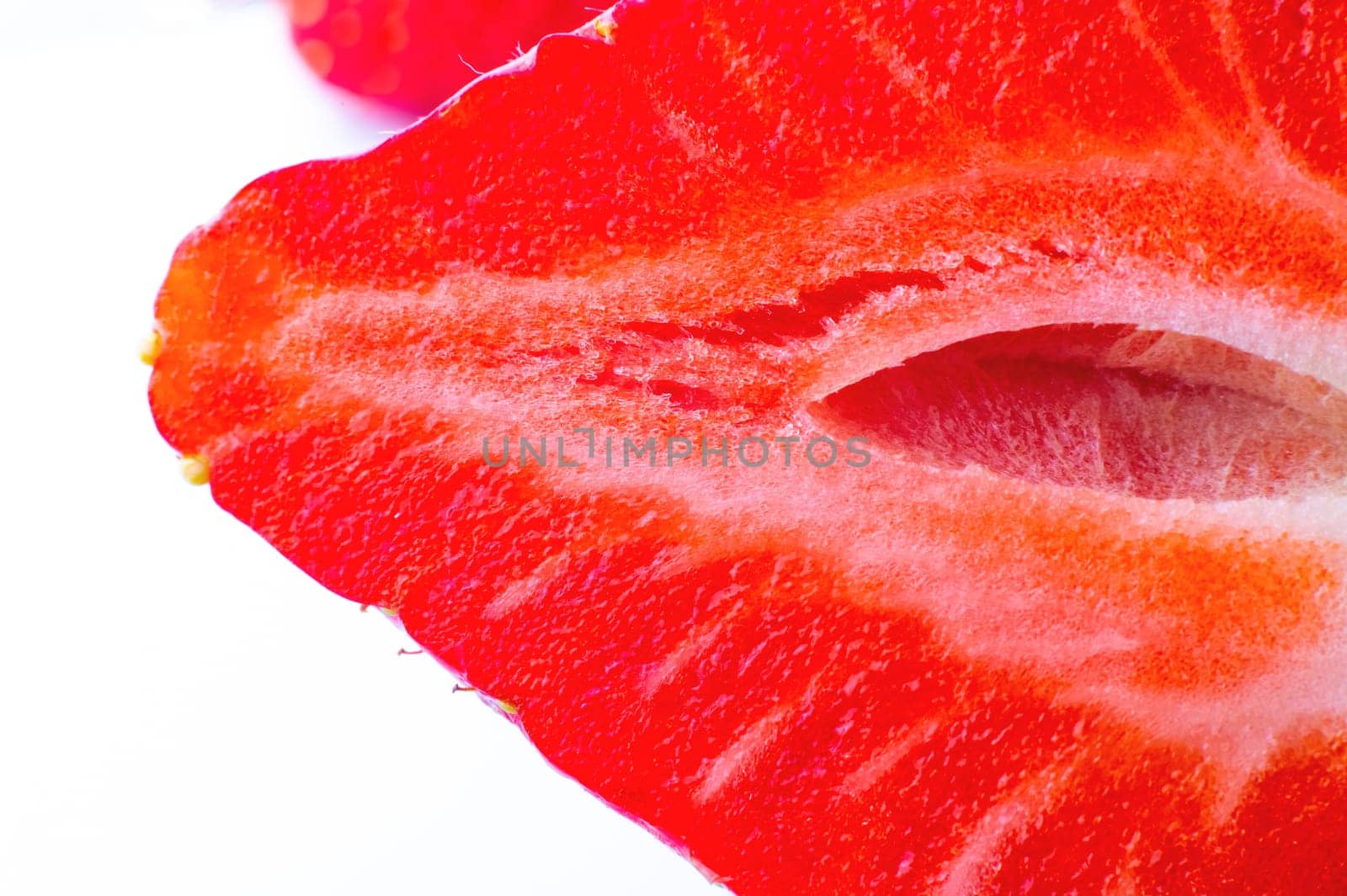 Fresh ripe strawberry fruit, on a white background, close-up. Macro shot of fiber in cut strawberries.
