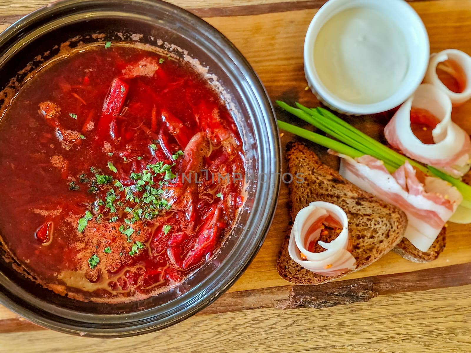 Traditional Ukrainian Russian borscht . Bowl of red beet root soup borsch with white cream . Beet Root delicious soup .