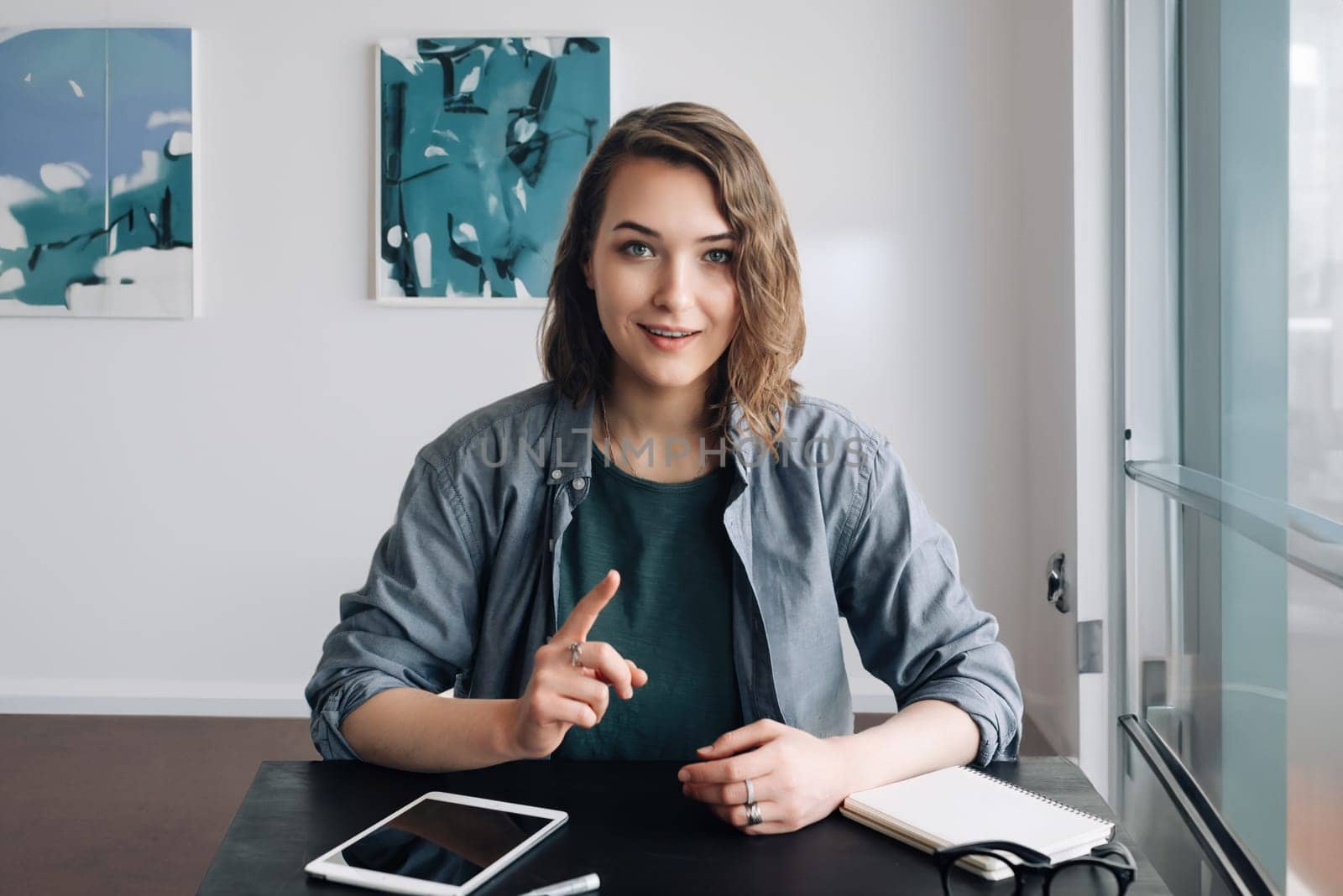 Confident Young Woman Engaging in a Video Conference, Communicating through Web Camera from Office or Home. Life Coaching and Online Business Meeting Concept. Modern Technology