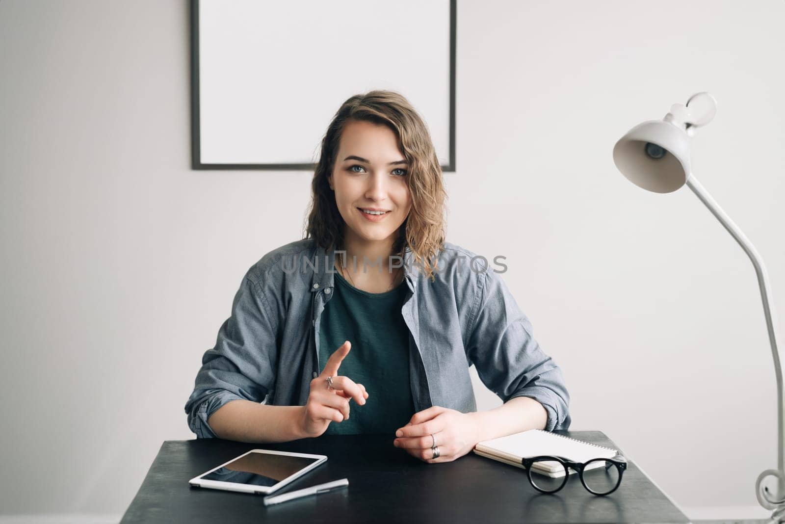 Young Businesswoman Conducting a Video Conference from Office or Home, Engaged and Confident, Demonstrating Life Coaching and Online Business Meeting Concept. Technology Communication in Modern Work.