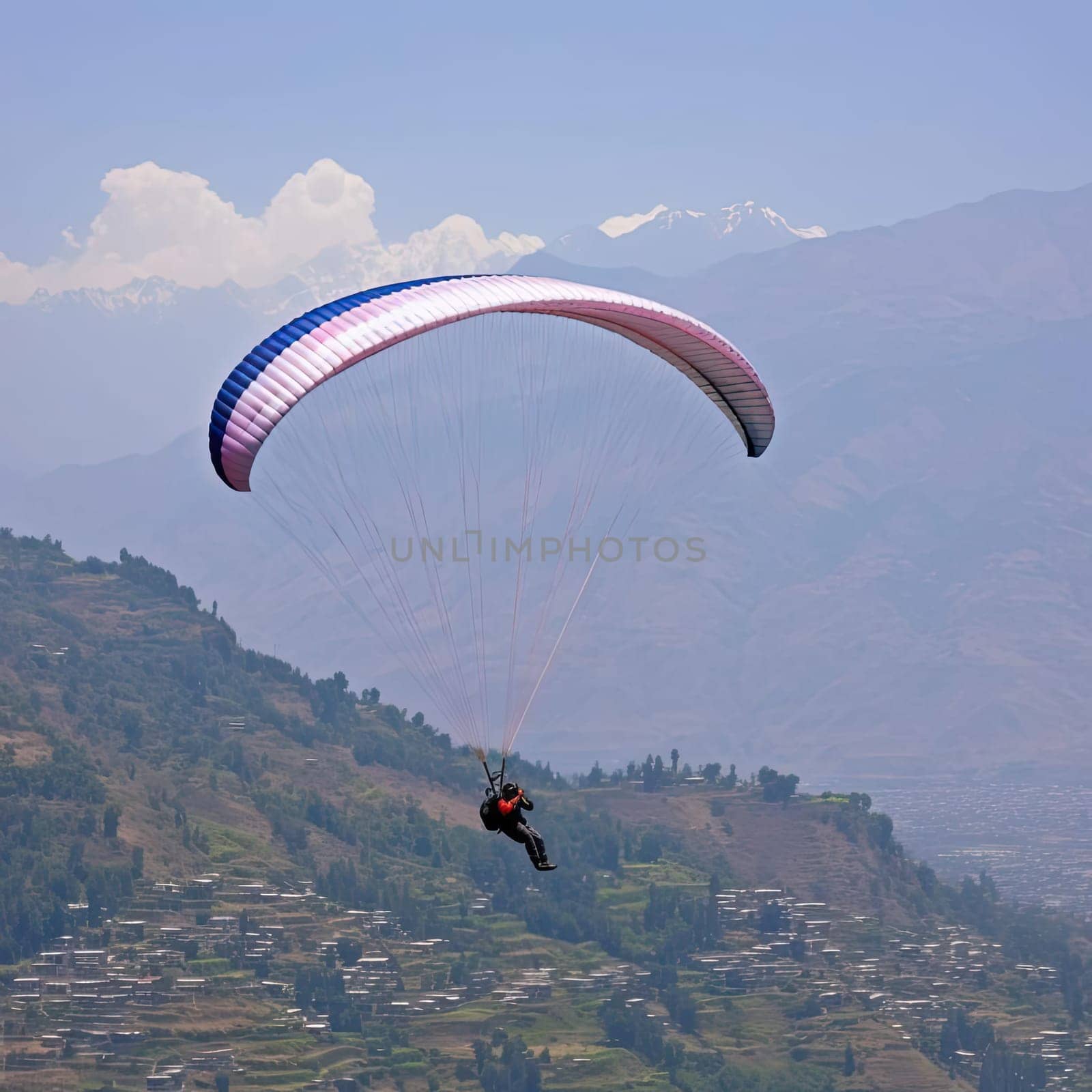 Paraglider flying over the mountains (ID: 001242)