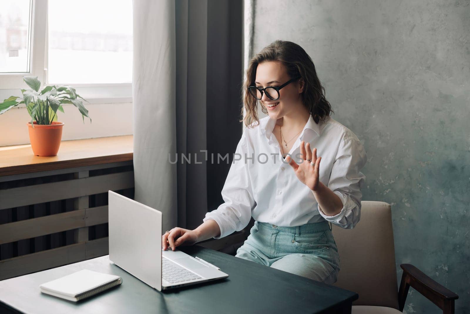 Digital Business Connection: Smiling Young Woman Leading Online Business Meeting, Embracing Remote Work as a Young Businesswoman or Freelancer Engaged in Virtual Collaboration on Laptop. by ViShark