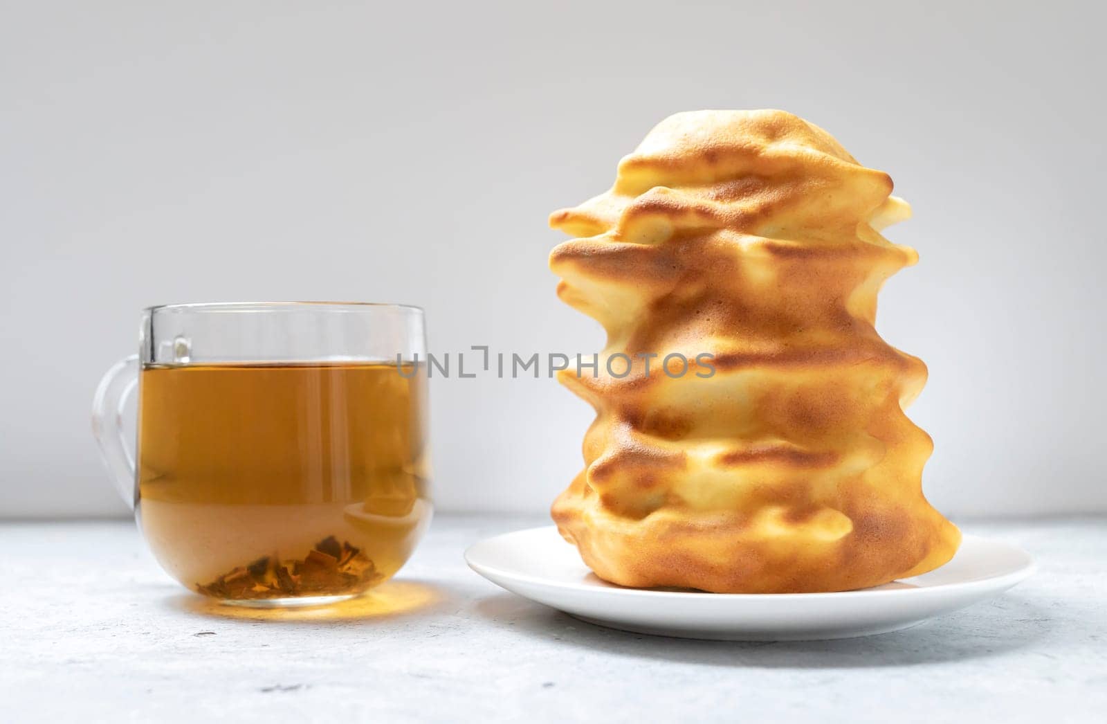 Sakotis ,sekacz, baumkuchen is traditional spit cake in Lithuanian, Polish, German, Belarusian cuisine made of butter, eggs, flour, sugar cooked on rotating spit over open fire. Cup of tea.Horizontal