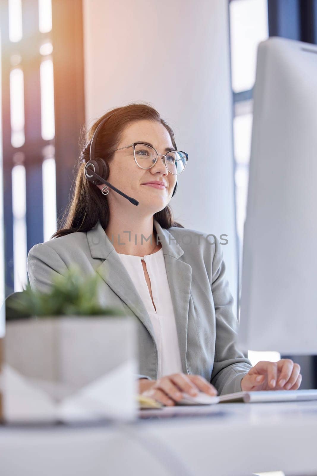 Woman, telemarketing and typing computer in call center office for customer service, crm support and consulting employee. Contact us, online communication and happy consultant agent working on pc.