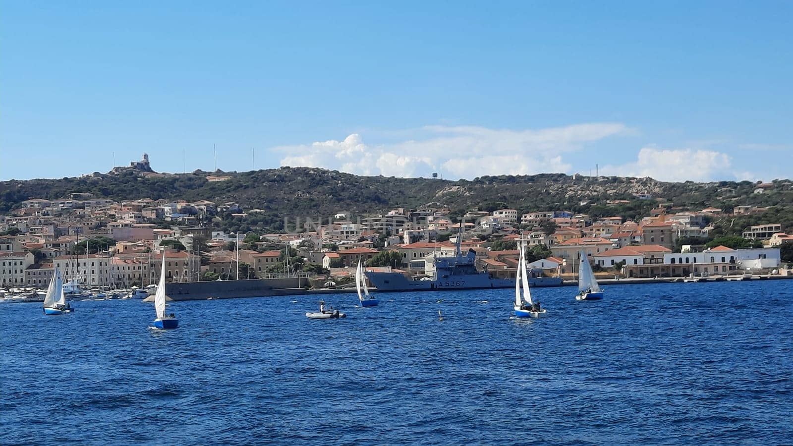 yachts are moored near the sea against the backdrop of mountains in the haze. High quality photo