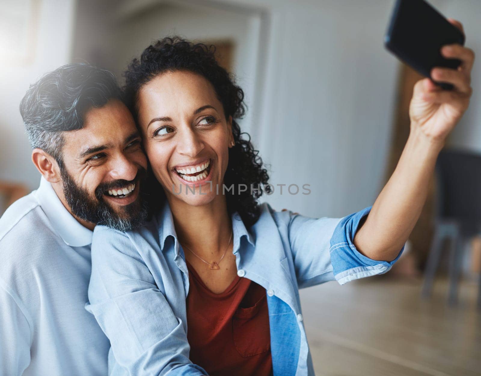 Happy couple, smile and selfie for profile picture, social media or vlog together relaxing at home. Man and woman in relationship smiling for photo, online post or memory and bonding in living room by YuriArcurs