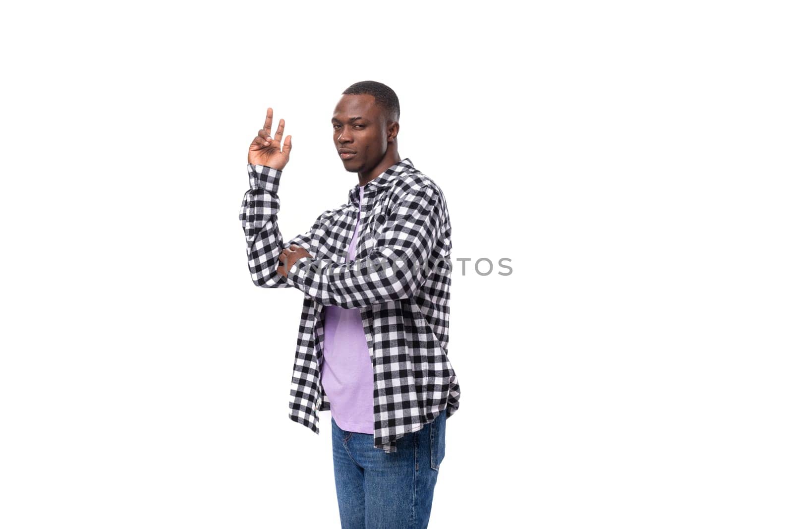 nice young american guy with short hair dressed casually dancing on a white background with copy space.