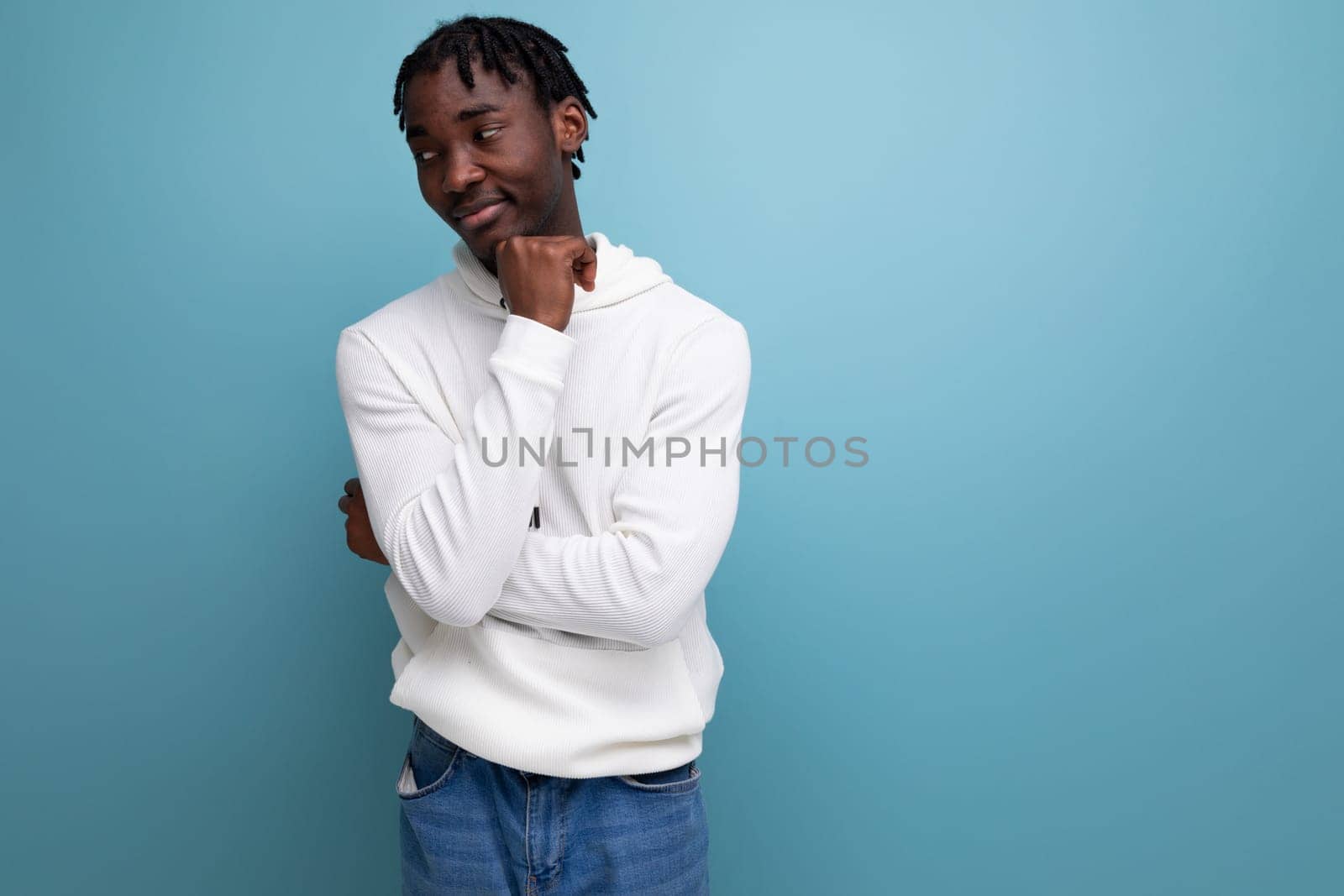 handsome optimistic man with dreadlocks on a blue background.