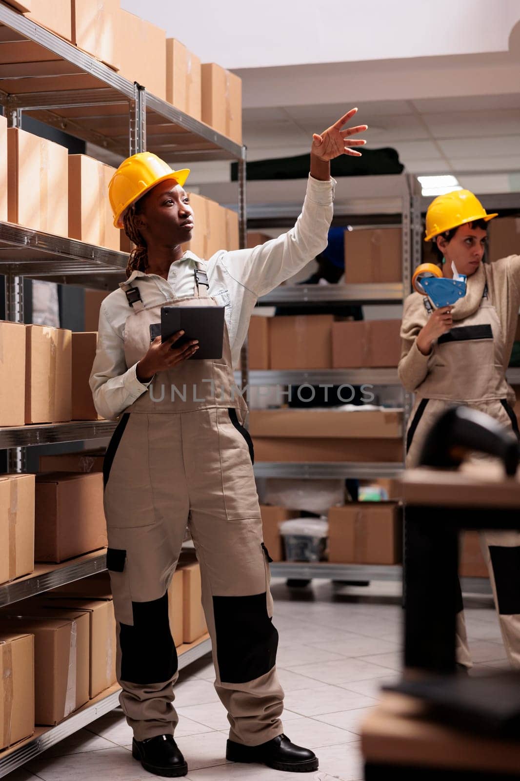 Woman storehouse operator working with digital tablet in warehouse by DCStudio