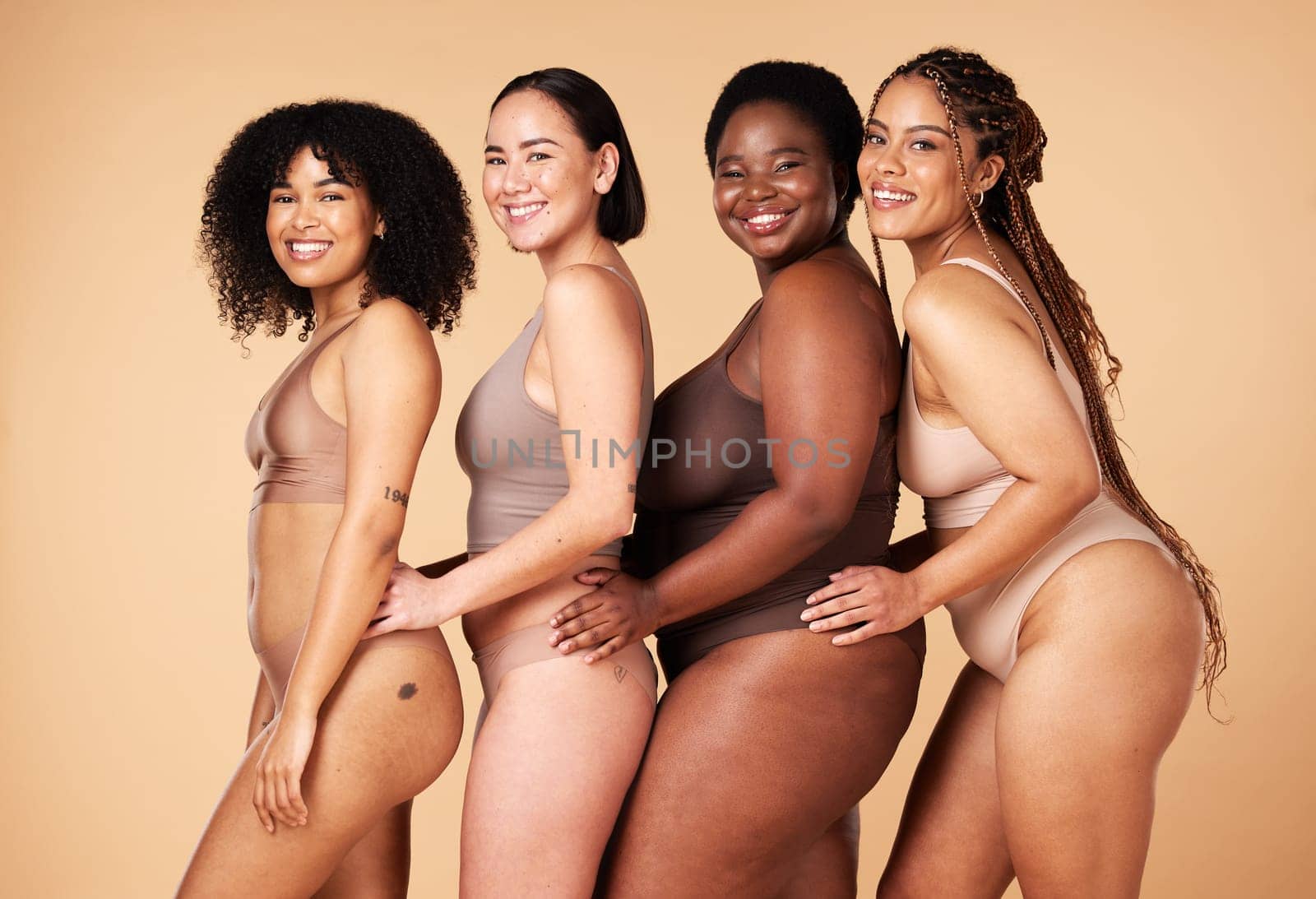 Diversity women, body shape and portrait of group together for inclusion, natural beauty and power. Underwear model friends happy on beige background with cellulite, pride and self love motivation by YuriArcurs