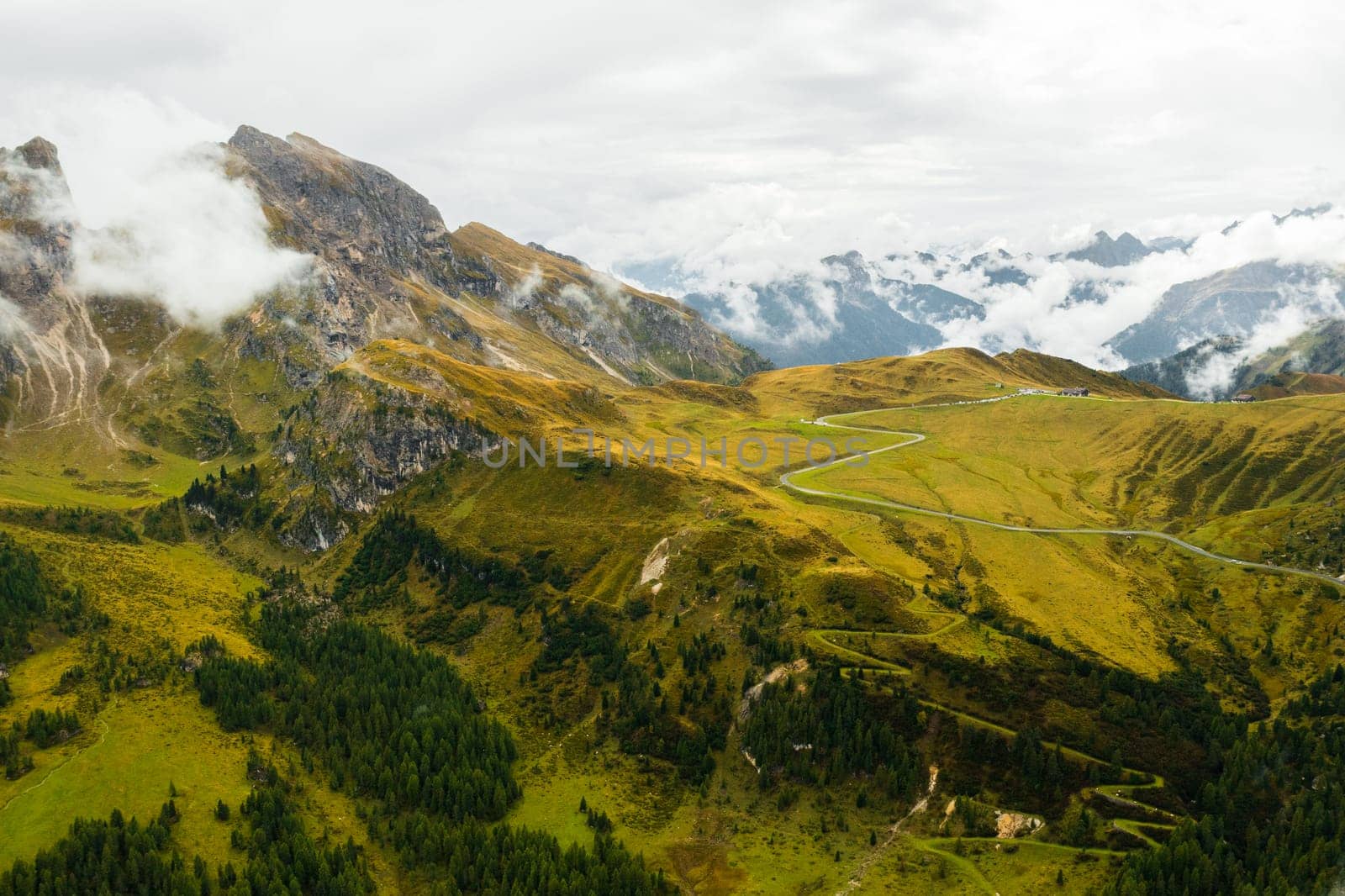 The mystical beauty of the Dolomite Alps as a blanket of clouds drapes over the valley, creating an ethereal atmosphere in the famous Giau Pass.