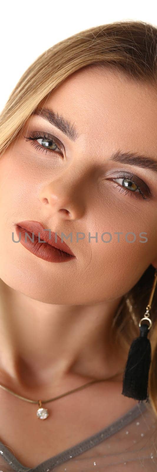 Portrait of a young beautiful woman with evening makeup with pigtails. Fashion nude makeup concept