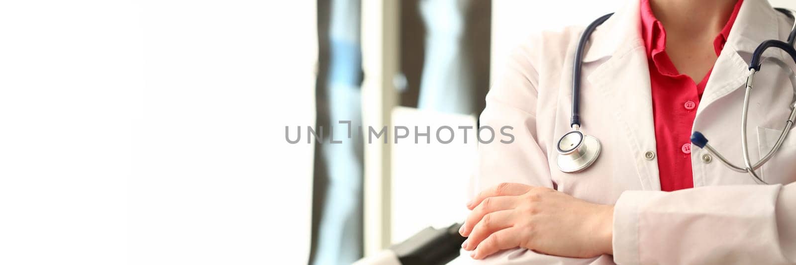 Silhouette of doctor with crossed arms in clinic. Health insurance and services concept