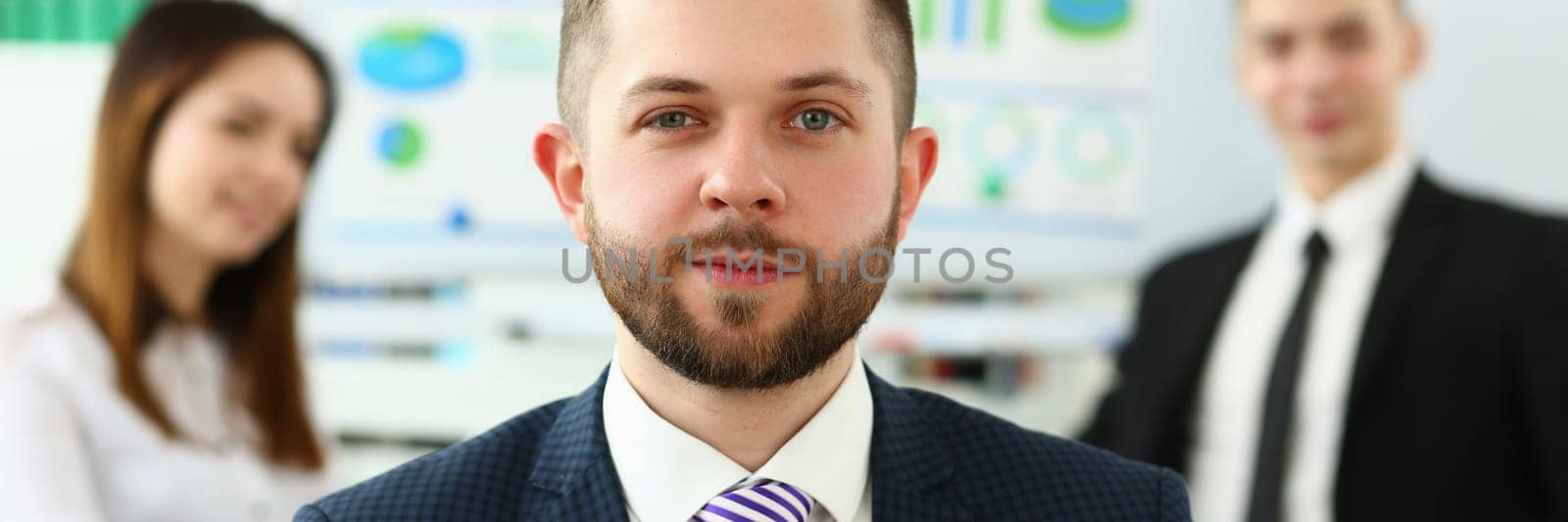 Confident smiling business man professional trainer with holding pen by kuprevich