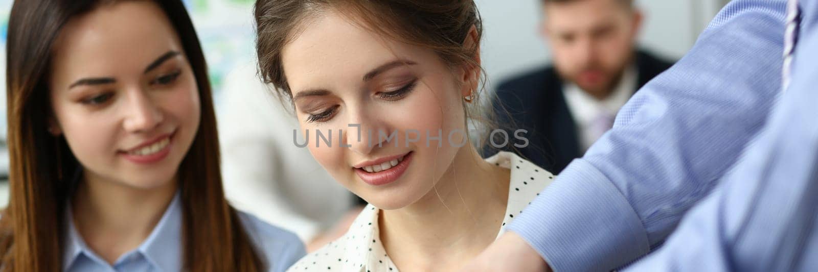 Beautiful caucasian woman signs a business document at business meeting by kuprevich