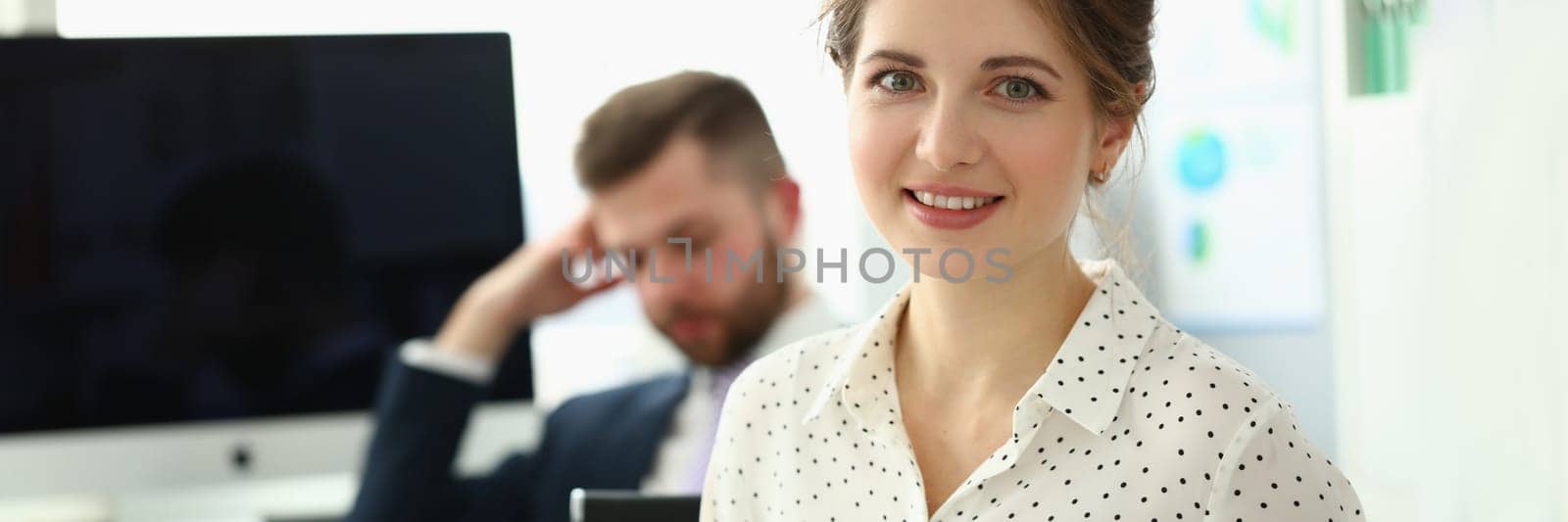 Business lady with positive look and cheerful smile poses for camera by kuprevich