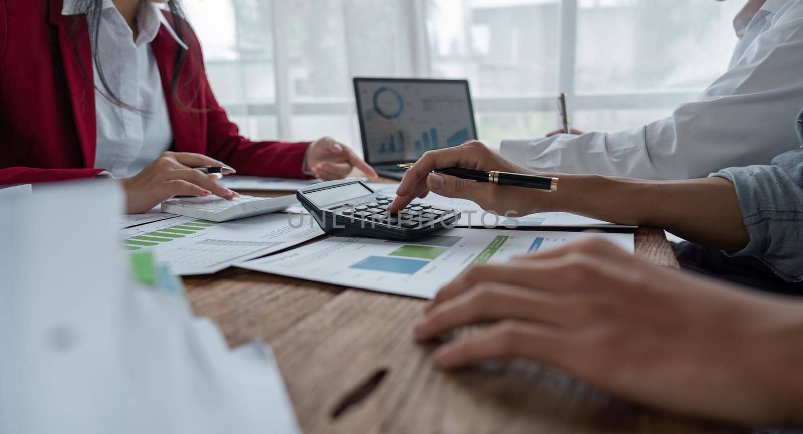 Team Of Business working at office with documents on his desk, doing planning analyzing the use a financial calculator, business plan investment, finance analysis concept.