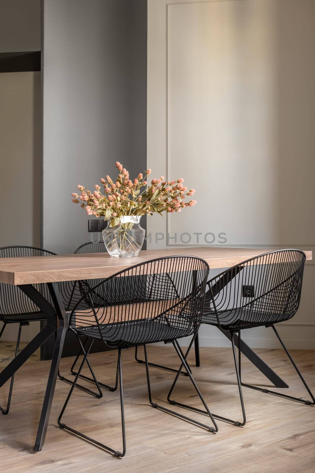 Modern indoor furniture with wood table, flower vase, and plant accents in a stylish apartment living room by apavlin