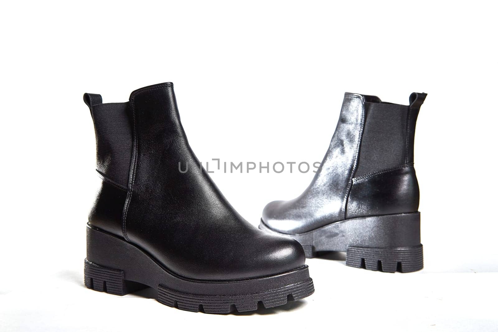 Female winter, autumn or spring black leather shoes in studio. Fashionable modern photography for store, catalog, magazine or online