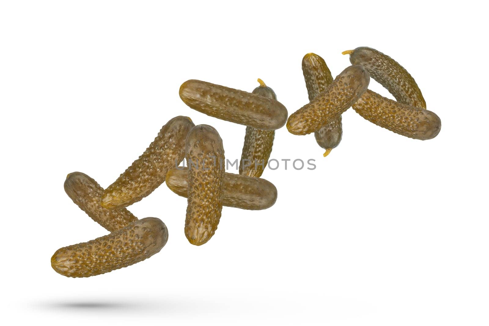 Pickled cucumbers on a white isolated background. Cucumbers of different sizes scatter in different directions. The concept of canning, pickling and harvesting vegetables