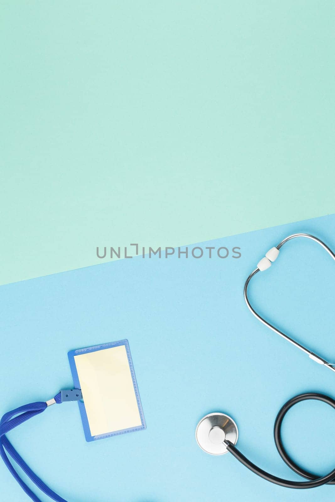 Stethoscope with badge on color isolated background. Top view medical worker desktop concept. Nurse workplace.