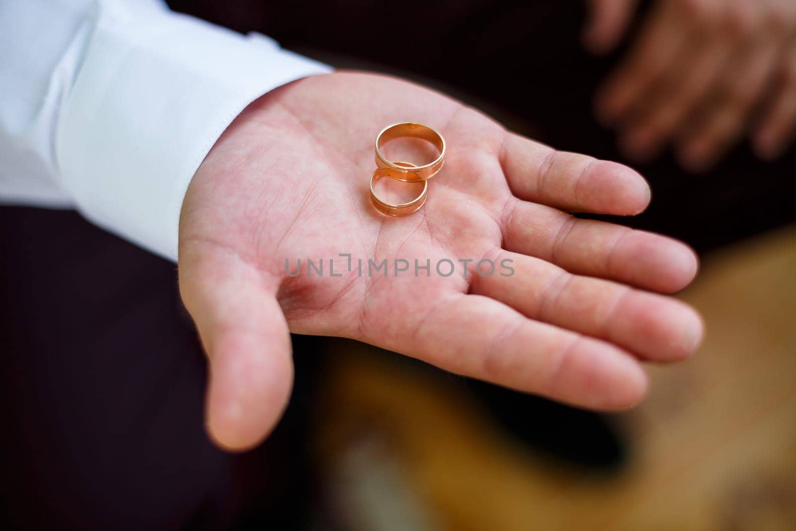 gold wedding rings in the hands of the newlyweds by Dmitrytph