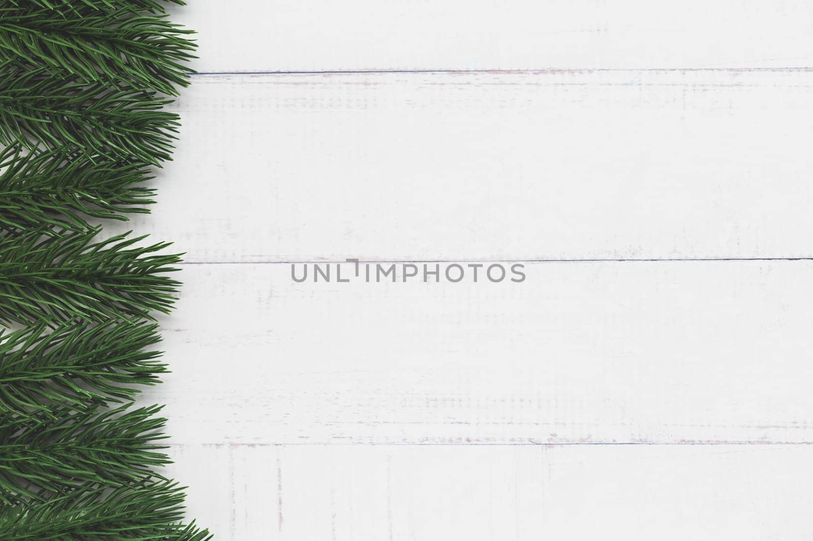 Top view of fir tree branches on white table background for nature and Christmas decoration concept
