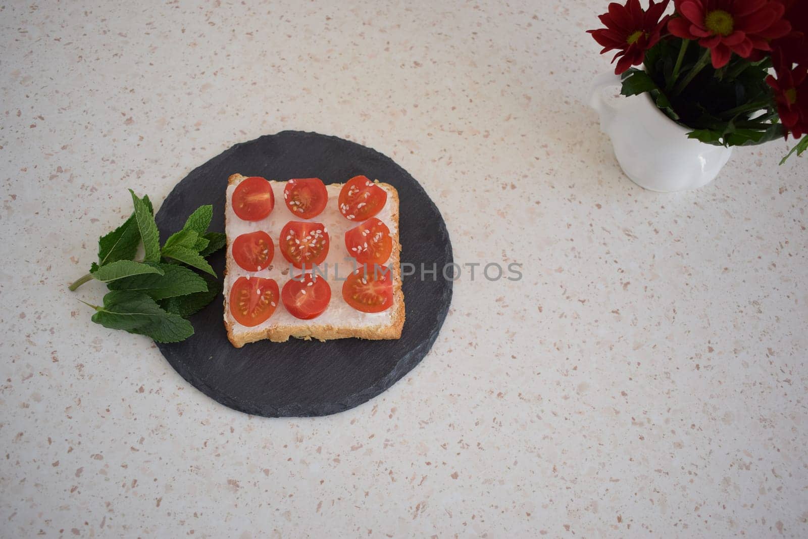 Healthy breakfast toast with tomatoes, ricotta and herbs.