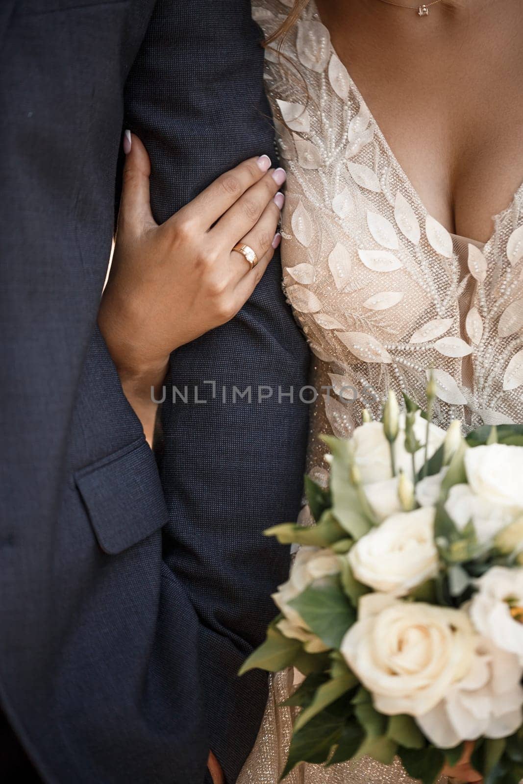 Wedding bouquet with fresh natural flowers in the hands of the bride by Dmitrytph