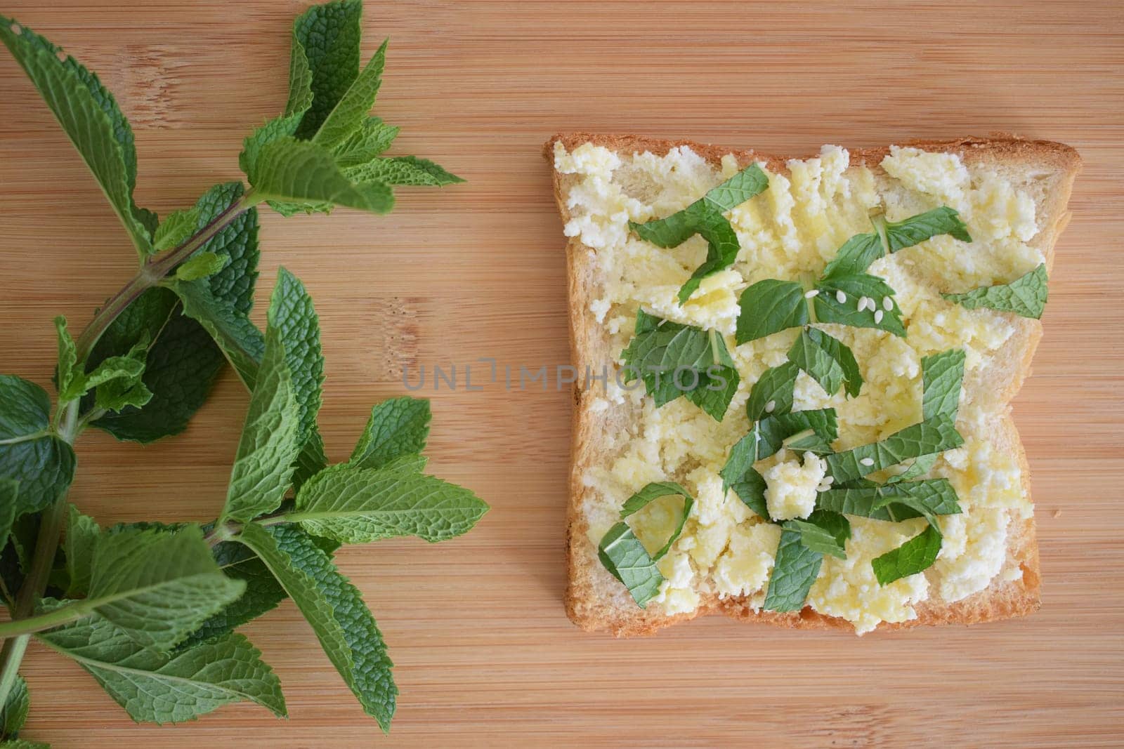 Healthy toast for breakfast with avocado, eggs, tomatoes, arugula etc.