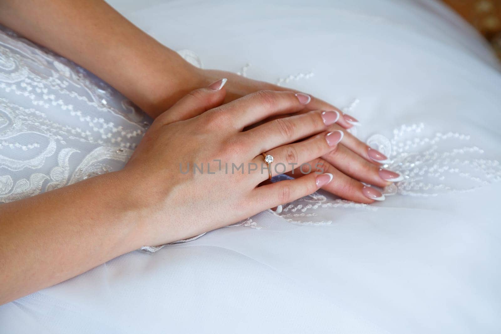 gold wedding rings in hands of newlyweds on wedding day