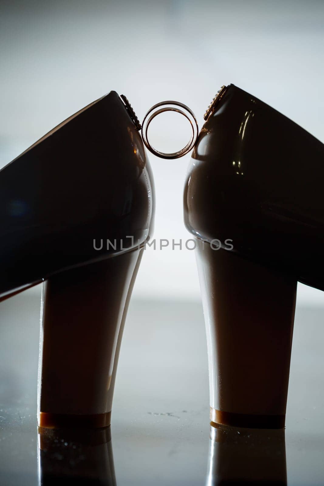 Gold wedding ring with women's shoes on the wedding day