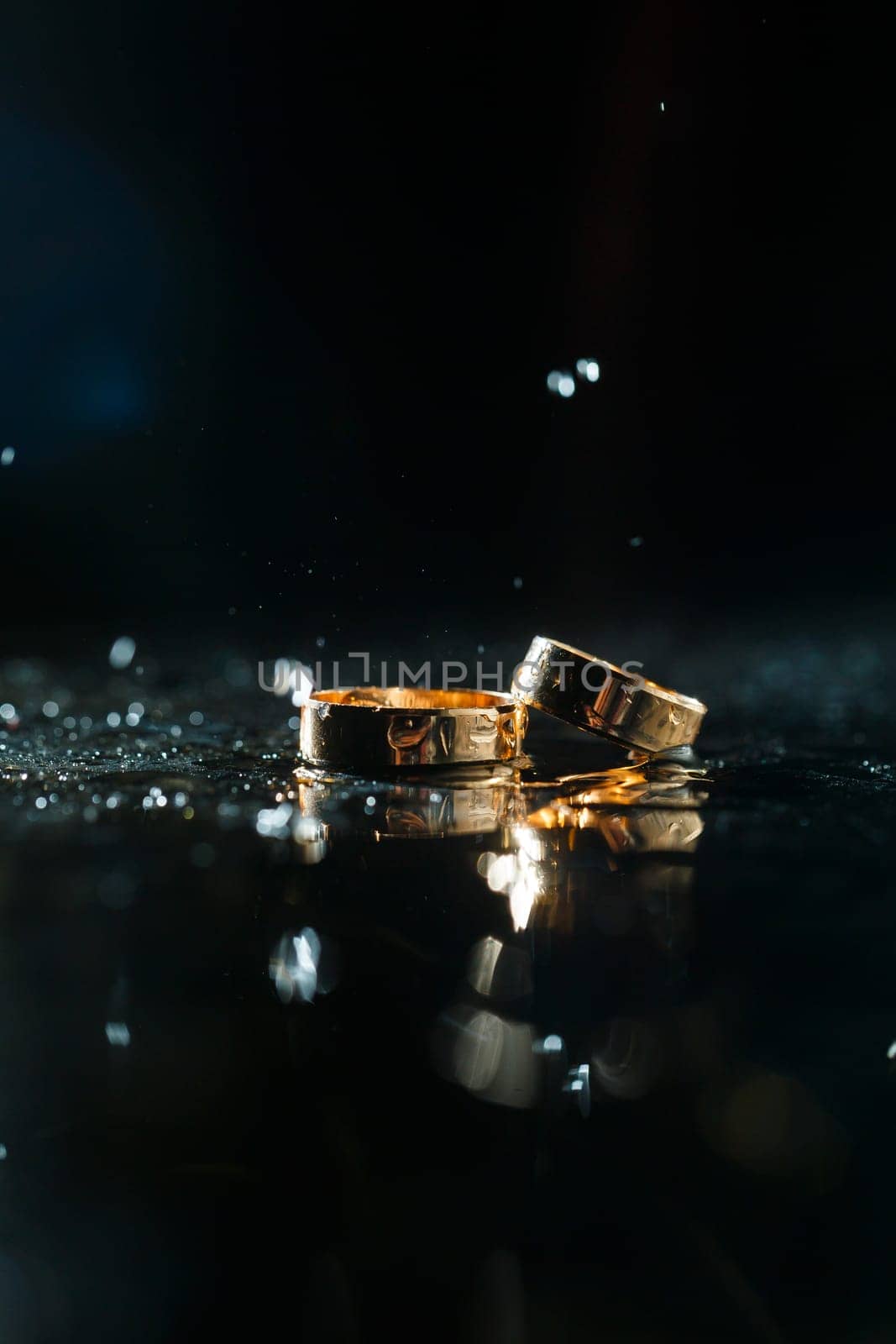 Gold wedding rings with water splashes