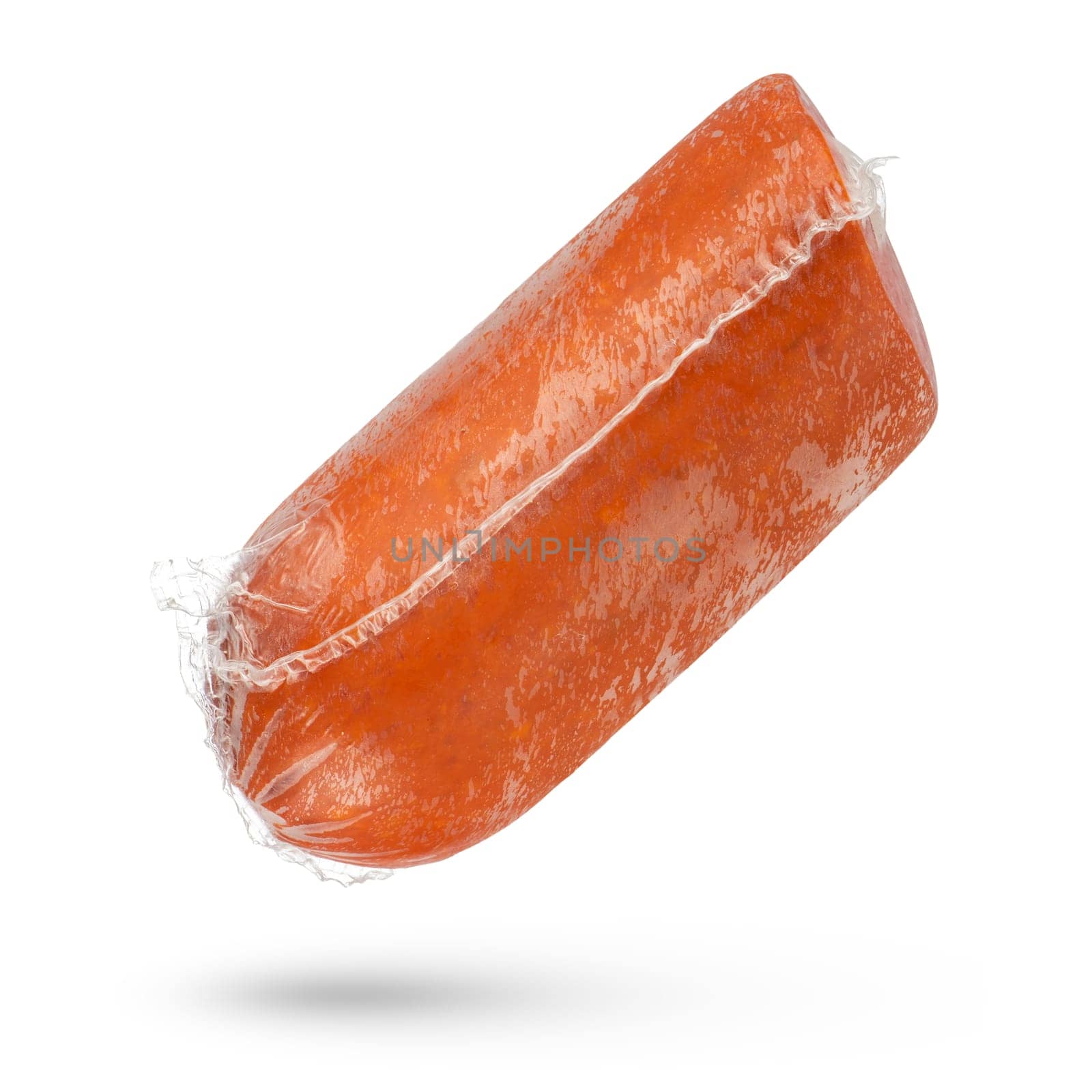 Packed salami sausage close-up on a white isolated background. The sausage hangs or falls, casting a shadow. Salami is packed in a protective film. by SERSOL