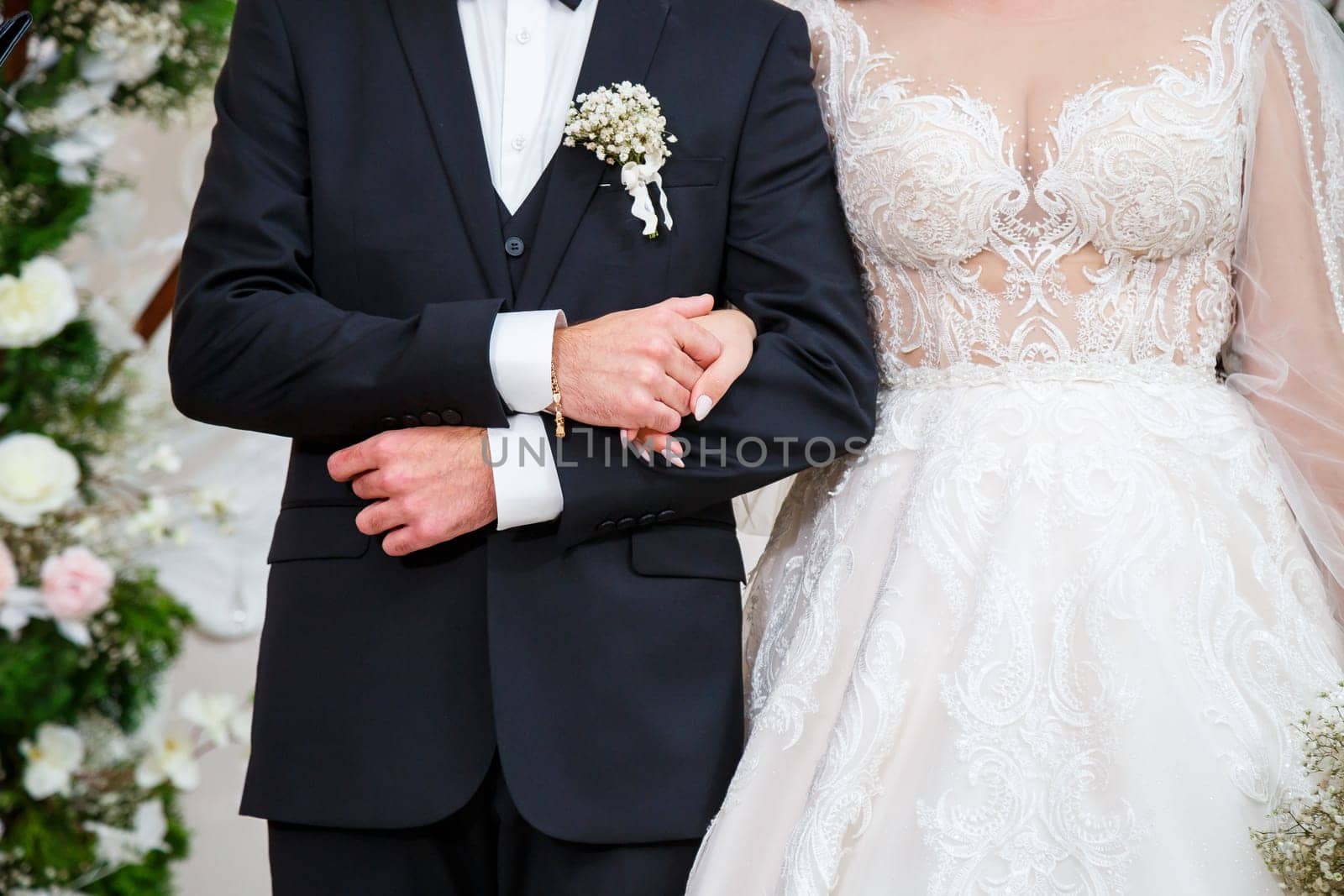 Newlyweds on wedding day, wedding couple holding hands, bride and groom