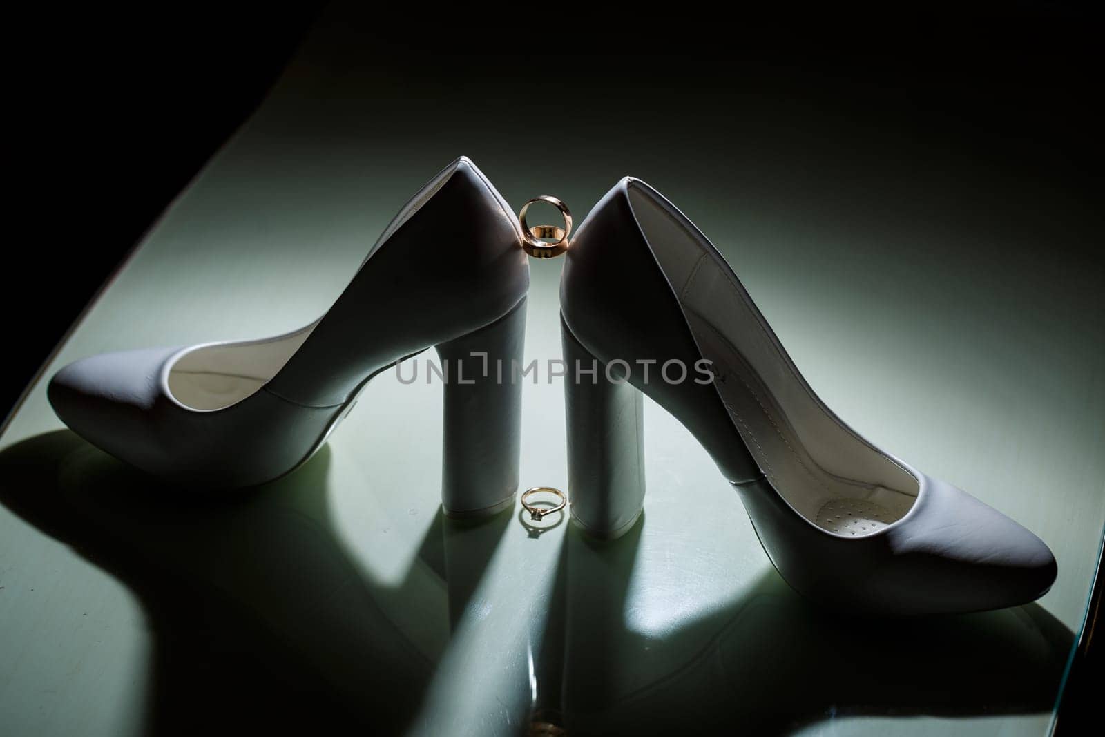 Gold wedding ring with women's shoes on the wedding day