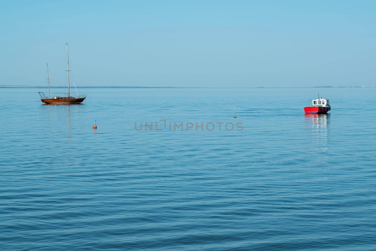 yachts on the water against the blue sky by roman112007