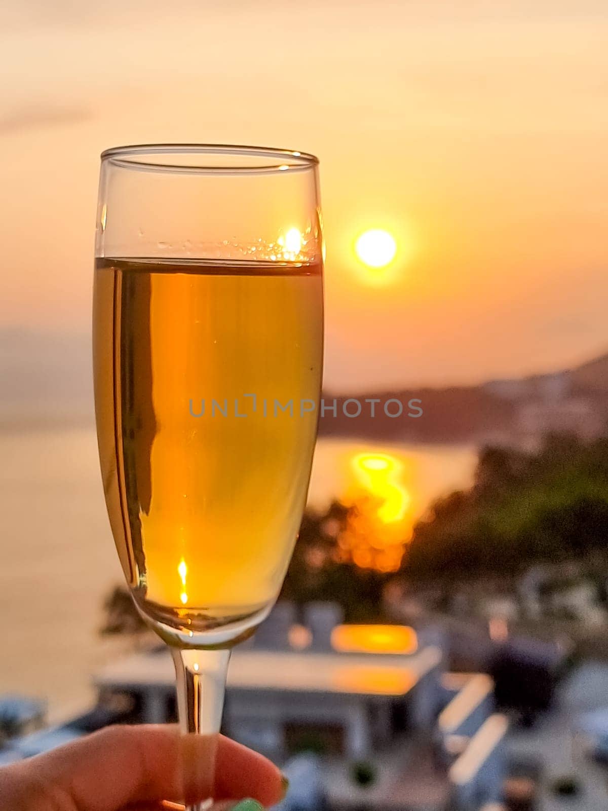 Caucasian woman hand holding champagne glass relax and enjoy luxury outdoor lifestyle while travel