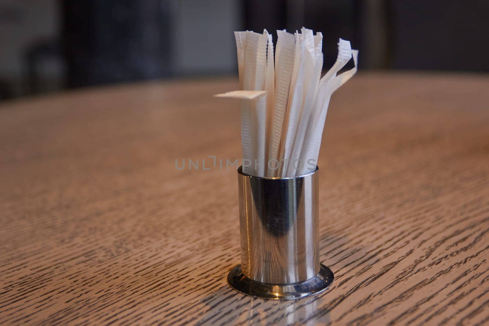 Photo of metal stand with toothpicks on table. by electrovenik