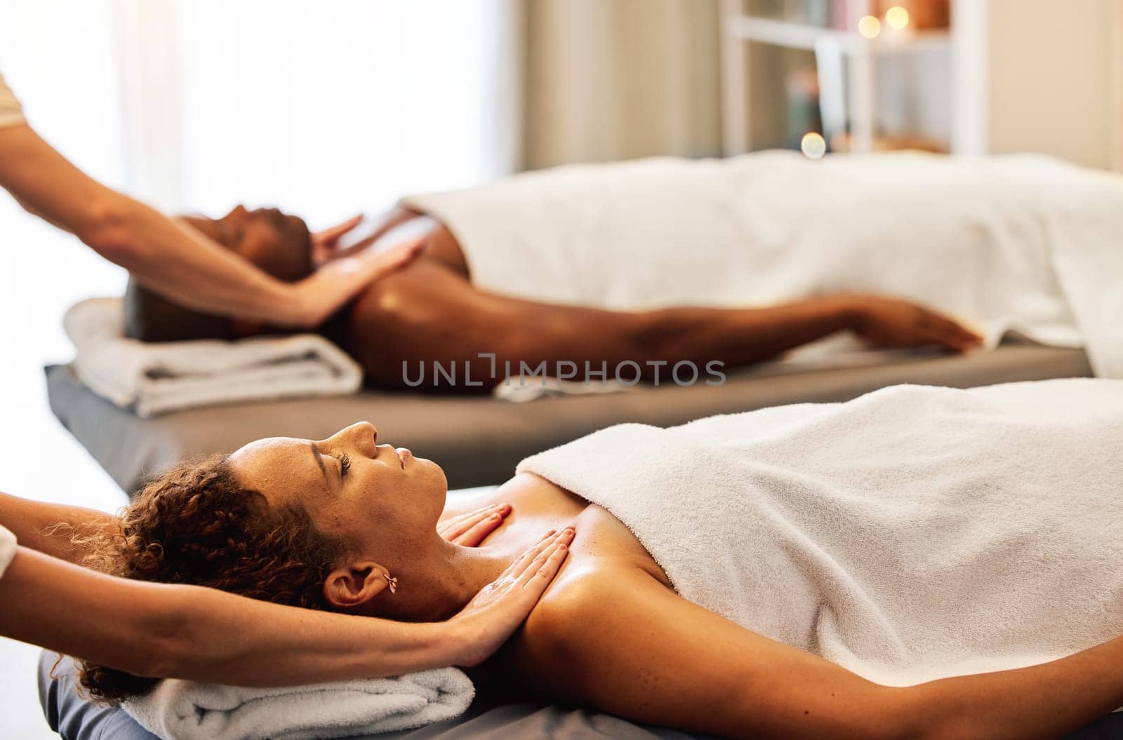 Spa, relax and couple massage for luxury wellness therapy or skincare health with masseuse hands. Zen physcial therapy, African man and woman body detox and peace at beauty salon for calm bodycare by YuriArcurs