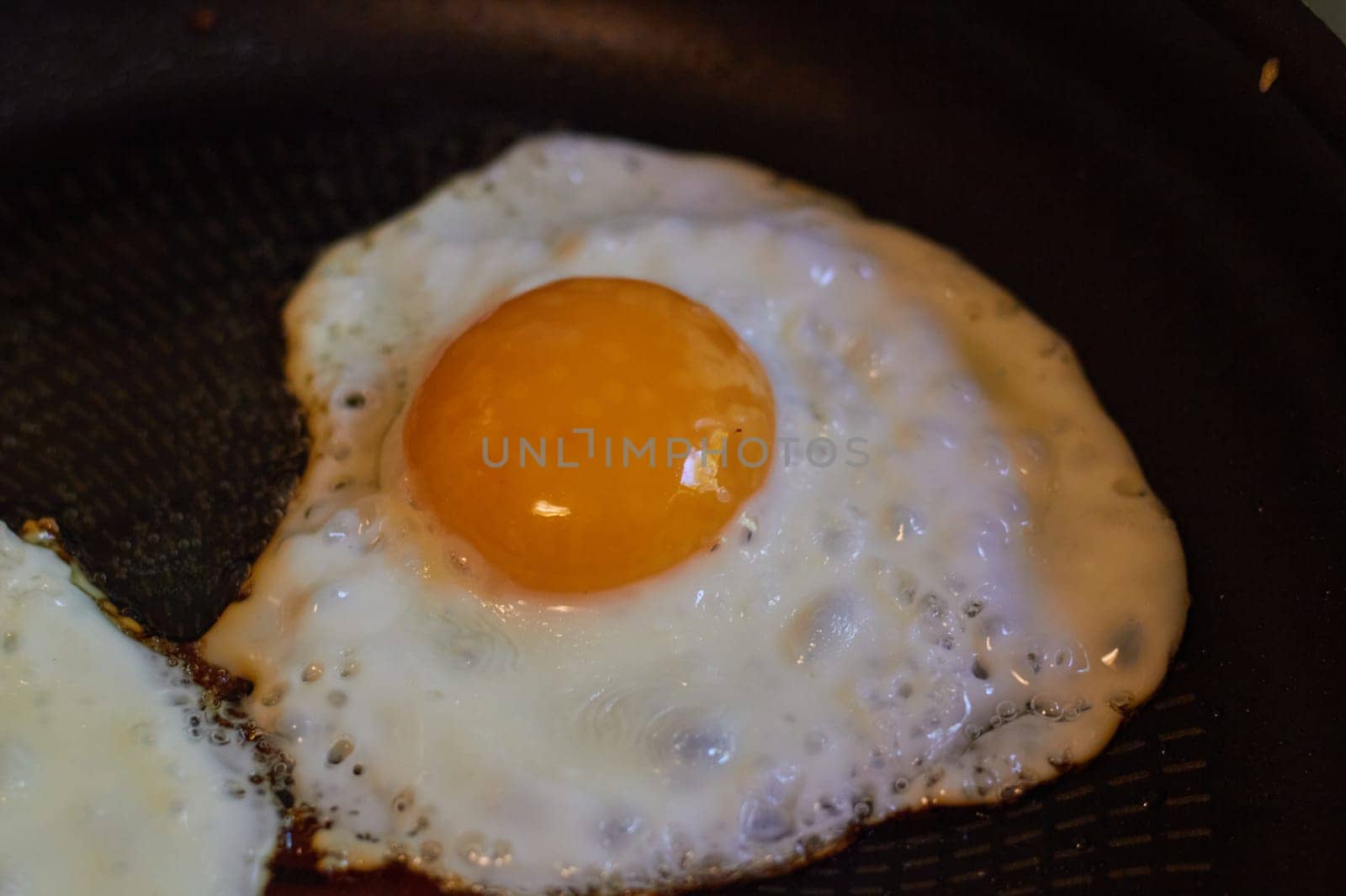 Photo scrambled eggs fried egg yolk and protein in frying pan. Breakfast. Fast food. Diet. Food preparation.