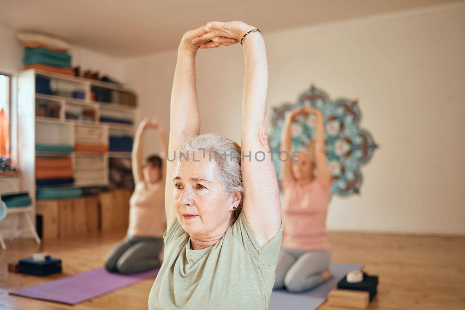 Yoga, fitness and senior woman in studio doing workout, stretching and training in exercise class. Wellness, retirement and active elderly female doing pilates, exercising and balance in gym lesson by YuriArcurs