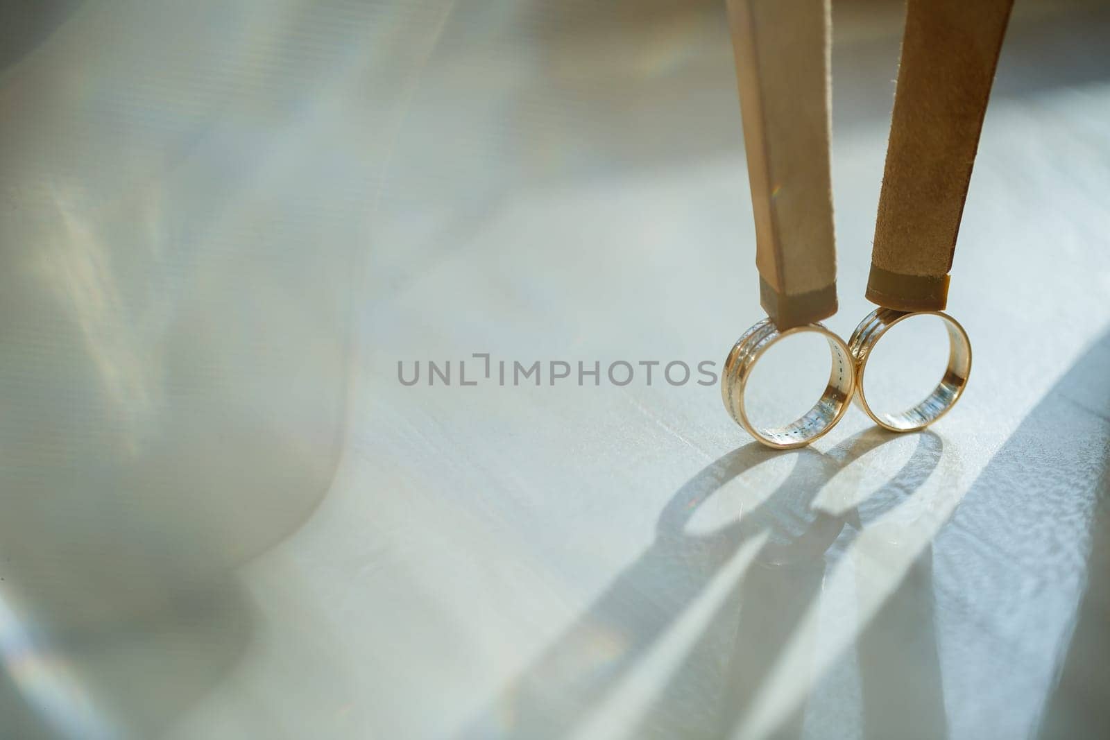 Gold wedding ring with women's shoes on the wedding day