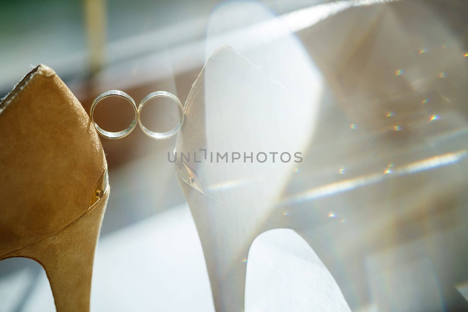 Gold wedding ring with women's shoes on the wedding day
