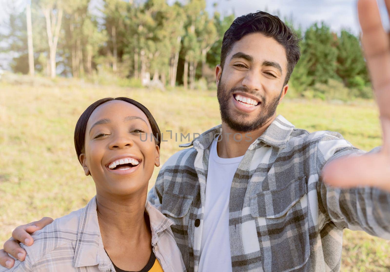 Portrait, interracial and couple in nature, love and happiness on vacation, romance and bonding. Romantic, black woman and happy man in countryside, holiday and adventure for quality time and loving.