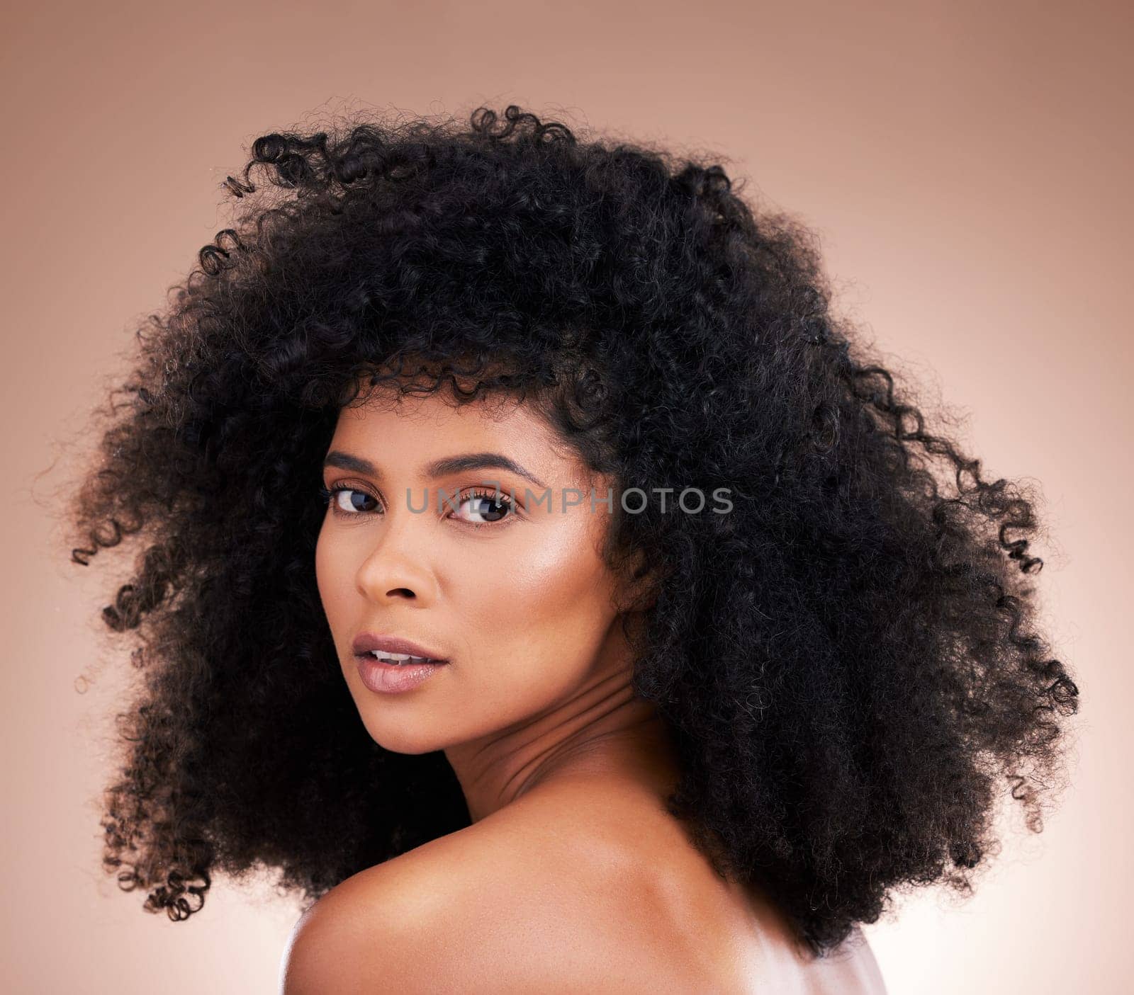 Hair, face and beauty with black woman in portrait, skin and natural cosmetics with glow on studio background. Female, cosmetic treatment with curly hairstyle, texture and growth with facial skincare.
