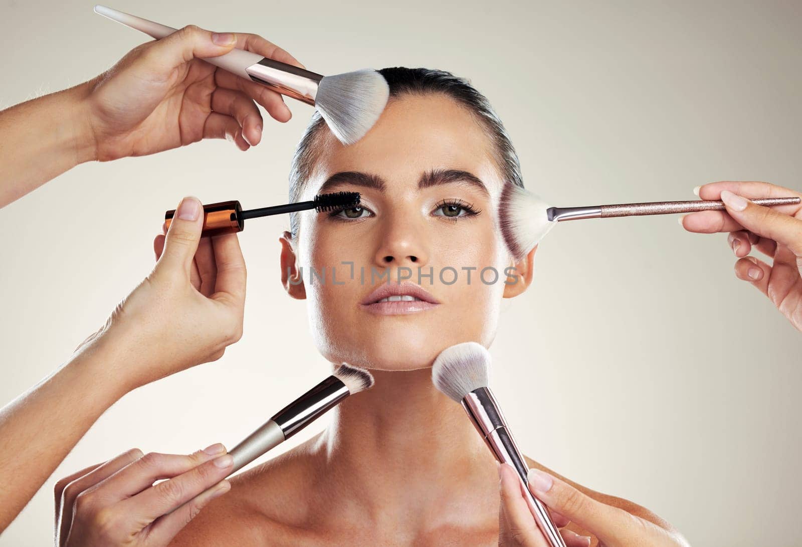 Makeup, beauty and brush on face of a woman in studio for powder cosmetic product. Aesthetic model person with professional hands for facial skincare and dermatology for skin glow and salon results.