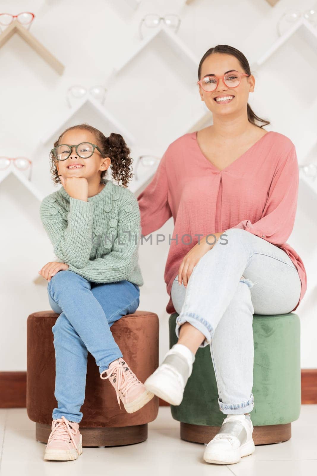Glasses, portrait and mother with her child at an eye clinic retail store for healthy vision and eyes wellness. Happy customer, mom and young girl enjoys shopping for quality eye care with insurance.